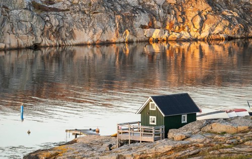 Small green boathouse, evening mood at sunset, Smögen, Smögenbryggan, Västra Götalands Län,