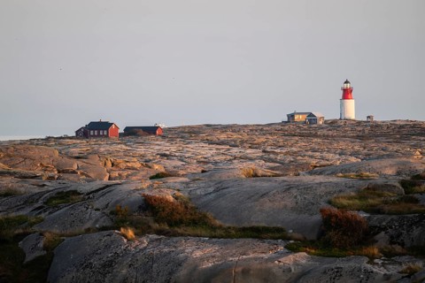 Lighthouse and houses in stony landscape at sunset, archipelago, Smögen, Smögenbryggan, Västra