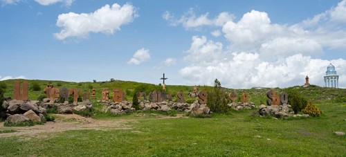 Panoramic view of a landscape with stone pillars and peaceful surroundings under a blue sky,