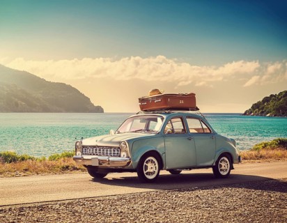 Holiday car luggage on beach, space for text. Summer vacation trip, AI generated