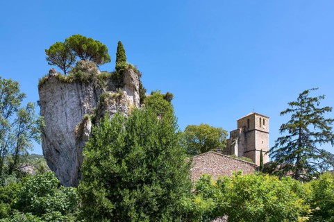 The Romanesque church of Sainte-Marie with its massive bell tower stands embedded in the green of