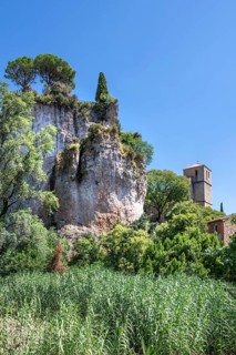 The Romanesque church of Sainte-Marie with its massive bell tower stands embedded in the green of
