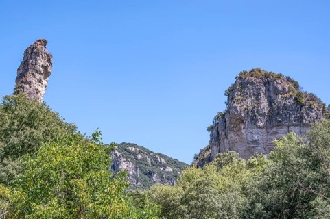 Two prominent dolomite cliffs formed by erosion - a towering peak on the left and a massive rock