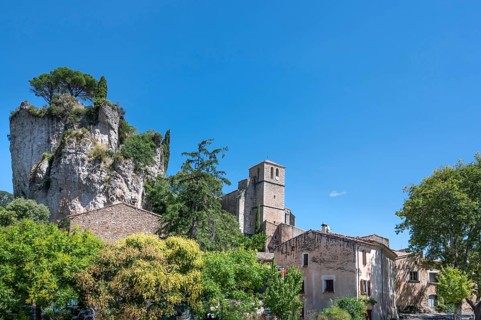 The Romanesque church of Sainte-Marie with its massive bell tower stands embedded in the green of