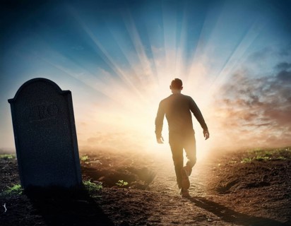 A silhouette of a lone figure walking off a gravestone, The scene evokes Resurrection thoughts