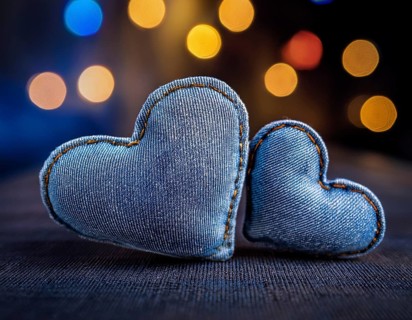 A beautiful heart-shaped denim pillow, symbolizing love and creativity, designed from repurposed