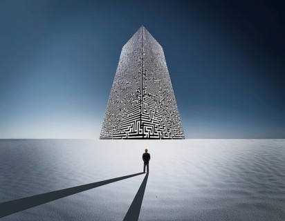 A lone individual stands at the edge of a large circular maze, contemplating choices and challenges