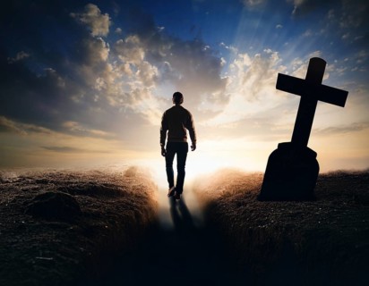 A silhouette of a lone figure walking off a gravestone, The scene evokes Resurrection thoughts