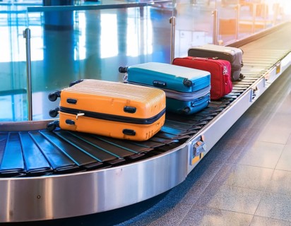 Baggage on a conveyor belt at an airport providing a travel and departure theme, AI generated
