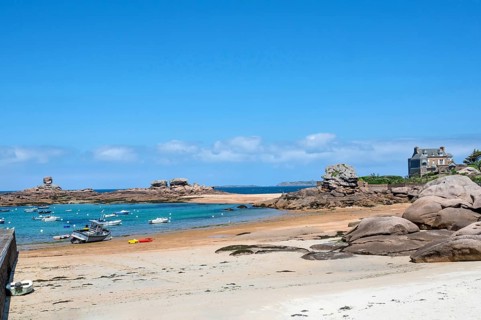 On the harbour beach of Tregastel on the Cote de Granit Rose, small sailing boats lie on the light