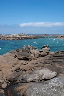 A picturesque coastal view of the pink granite coast near Tregastel shows the bay with the