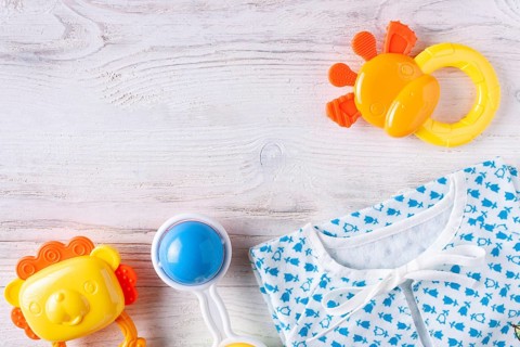 Things for a newborn on a white wooden background