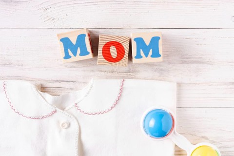 Newborn baby accessories on white wooden background