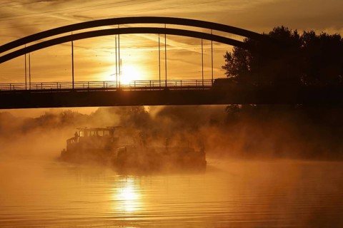 Ship on the Datteln-Hamm Canal in the morning fog at sunrise, Bergkamen, North Rhine-Westphalia,