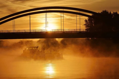 Ship on the Datteln-Hamm Canal in the morning fog at sunrise, Bergkamen, North Rhine-Westphalia,