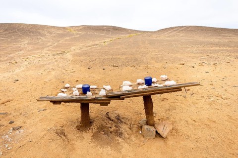 Pink salt displayed on wooden stands along the road to Namib-Naukluft National Park and Sandwich