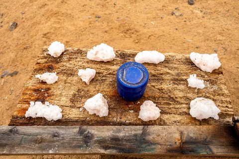 Pink salt displayed on wooden stands along the road to Namib-Naukluft National Park and Sandwich