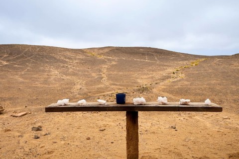 Pink salt displayed on wooden stands along the road to Namib-Naukluft National Park and Sandwich