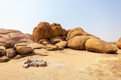 Granite peaks and rugged desert landscape at Spitzkoppe Community Campsite, Namibia. Golden