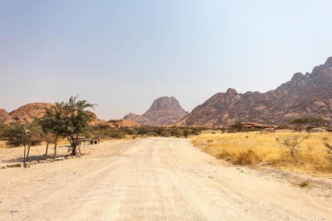 Granite peaks and rugged desert landscape at Spitzkoppe Community Campsite, Namibia. Golden