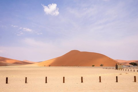Sossusvlei in Namibia is a desert wonder, famous for its giant red dunes, glowing at sunrise and