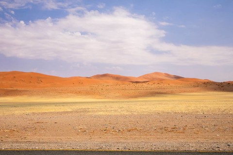 Sossusvlei in Namibia is a desert wonder, famous for its giant red dunes, glowing at sunrise and