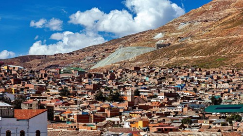 City view with many brick houses at the foot of the hills under a blue sky, The silver mountain