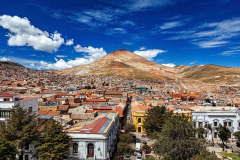 Lively city in front of a high mountain under an expressionist sky, the Cerro Rico silver mountain