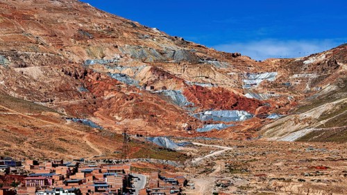 Reddish mountain landscape with visible mines under a clear sky, the Cerro Rico silver mountain in