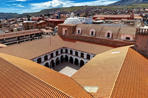 Architectural courtyard of a monastery with tiled roofs in a city, view over the city of Potosi in