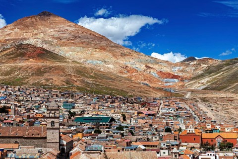 Panorama of a city at the foot of a mountain under a blue sky in the Andes, The silver mountain
