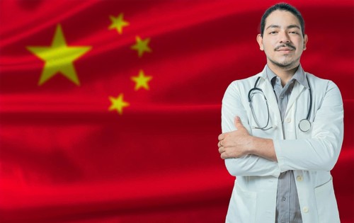 Male doctor on China flag. Doctor with crossed arms on China flag. China Health and Care concept