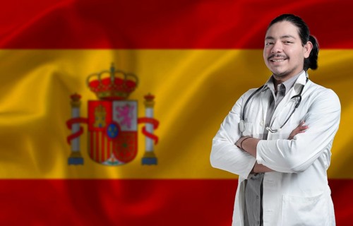 Spain Health and Care concept. Male doctor on Spain flag. Doctor with crossed arms on Spain flag