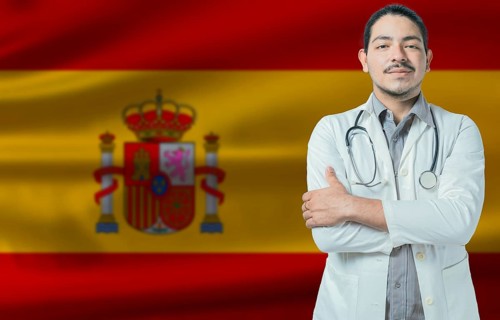 Male doctor on Spain flag. Doctor with crossed arms on Spain flag. Spain health and care concept