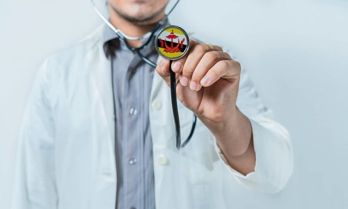 Brunei national healthcare. Doctor showing stethoscope with Brunei flag
