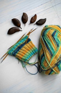 Coloured wool with started knitted sock