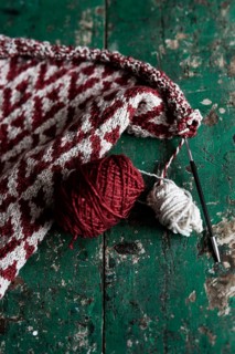 Knitted piece with ball of wool and knitting needle