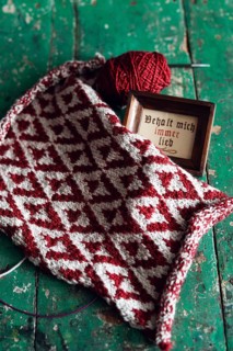 Knitted piece with ball of wool and framed picture with the lettering Behalt ich immer lieb