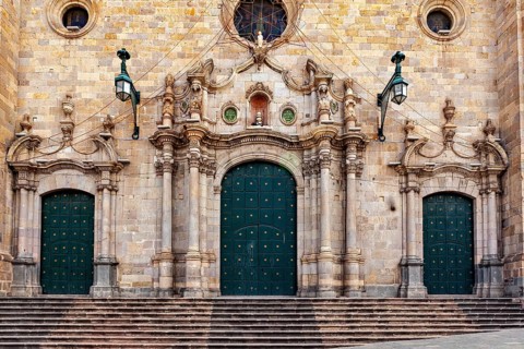 Monumental façade with three green double doors and complex decorations, impressive symmetry, The