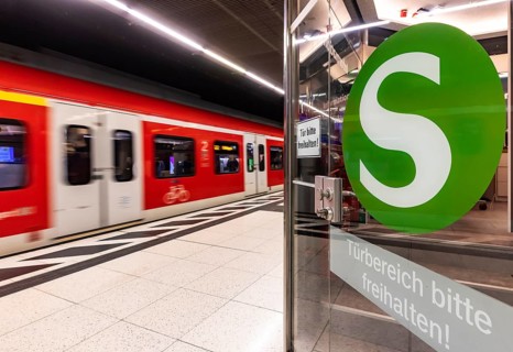 S-Bahn arriving underground at the main station stop. Platform with travellers and logo. Stuttgart,