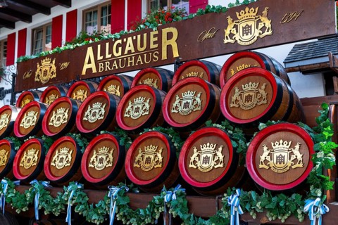 Representative wooden beer barrels on a wagon, Oberstdorf, Allgäu Alps, Bavaria, Germany