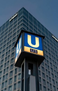 The picture shows a modern high-rise building in Berlin with the KPMG logo and a striking