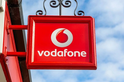Vodafone sign with logo on shopfront of Vodafone phone shop, Marlborough, Wiltshire, England, UK
