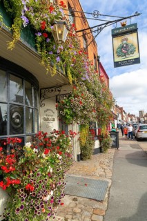 Colourful flowers in large window box and hanging baskets, Royal Oak public house, Marlborough,