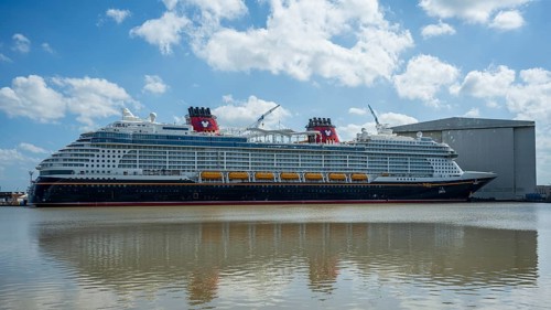 A large cruise ship moored next to a shipyard on a sunny day, cruise ship at the Meyer Werft