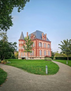 The Castel Rose in L'Isle-Adam, France. Historic mansion characterized by its pink walls and