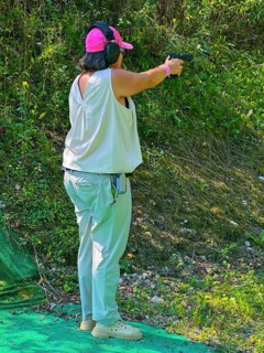 Woman Shooting on an Outdoor IPSC Shooting Range in a Sunny Summer Day in Switzerland