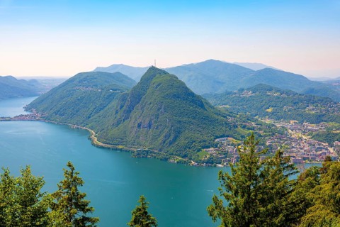 Panoramic View over Lake Lugano and Mountain View in the Swiss Alps and Cityscape in a Sunny Summer