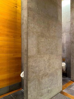 Luxury Men Urinal Bathroom with Wood and Stone Wall in Switzerland