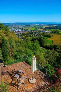 Panoramic View over City and Landscape with a Terrace with Chair and Parasol From Medieval Old Town